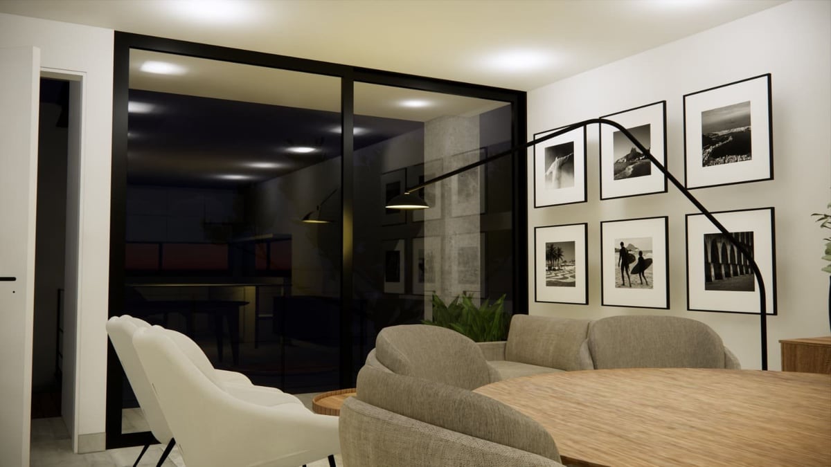 Modern dining room with wooden table, beige chairs, large black-framed glass partition, and gallery wall of framed photographs
